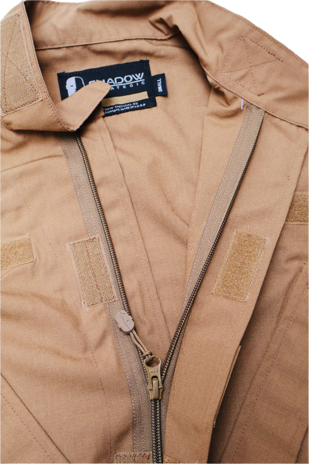 Close-up of a tan jacket with a brand label on the collar.