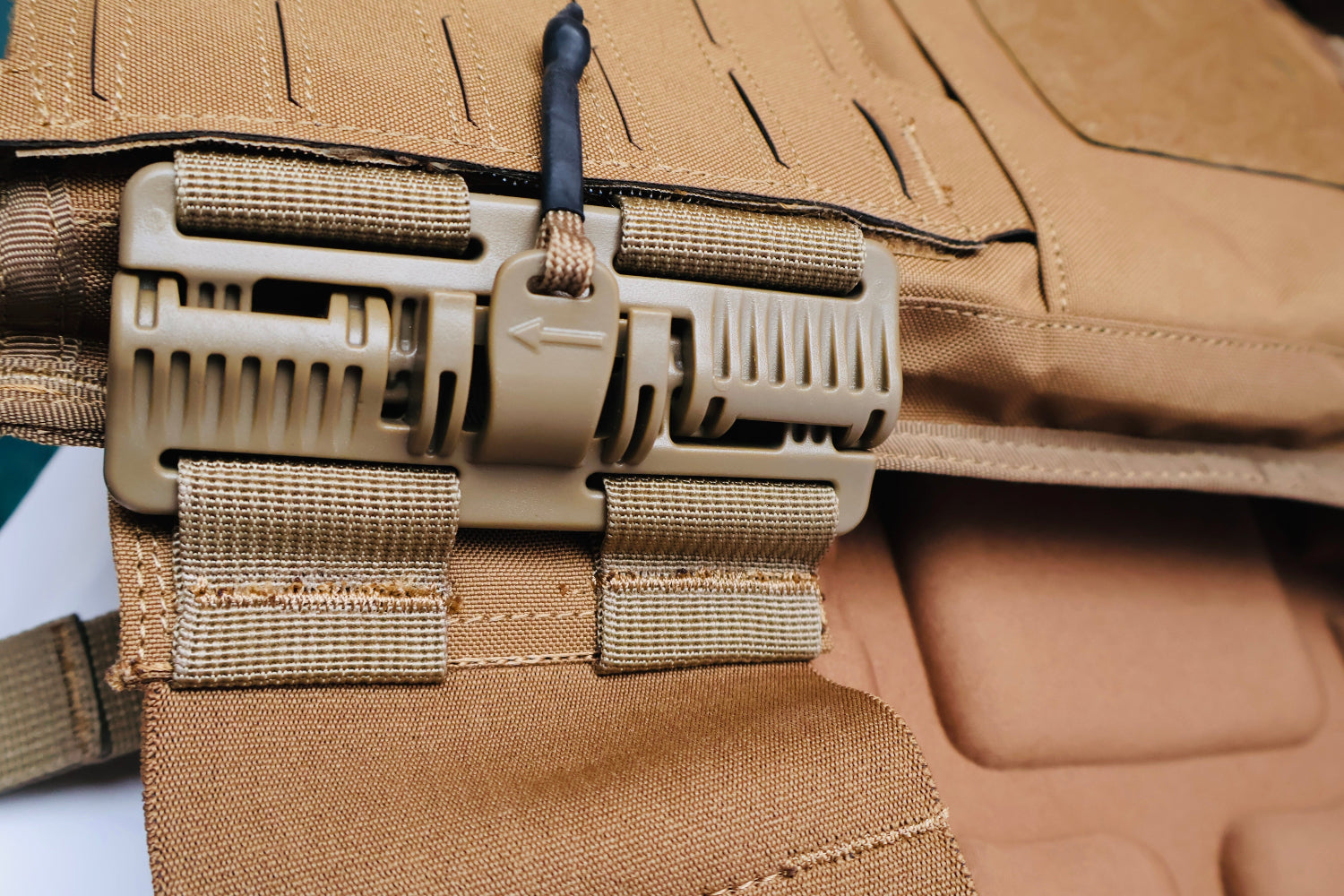 Close-up of a tactical vest with multiple straps and buckles.