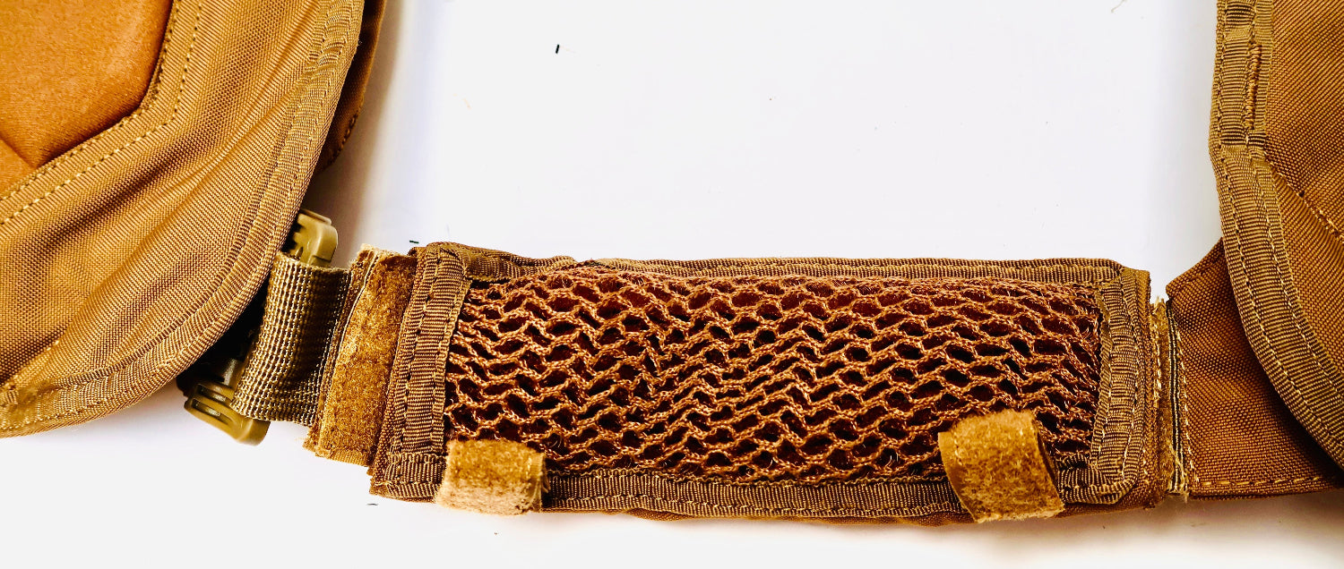 Close-up of a brown tactical belt with mesh design on a white background