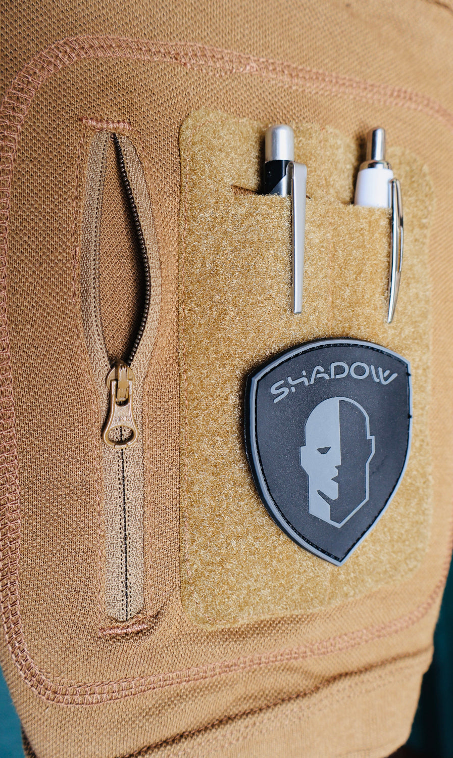 Tan tactical pouch with a 'Shadow' patch and zipper