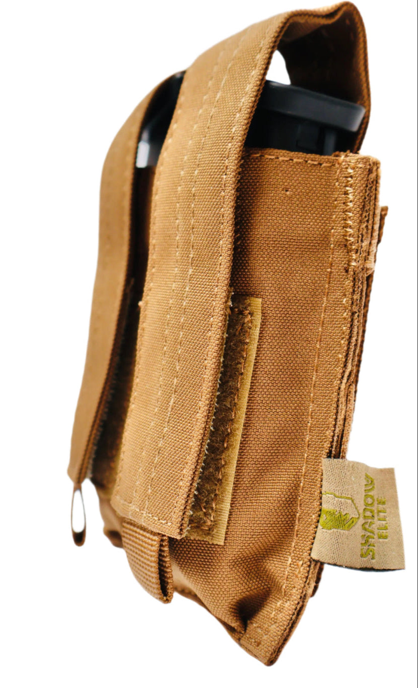 SHE-23030  Double Pistol GRIPTAC Tan tactical pouch with a black device inside on a white background