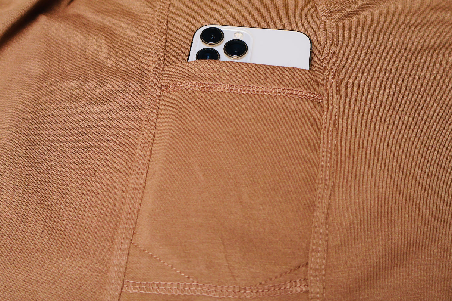 Smartphone in a pocket of brown fabric
