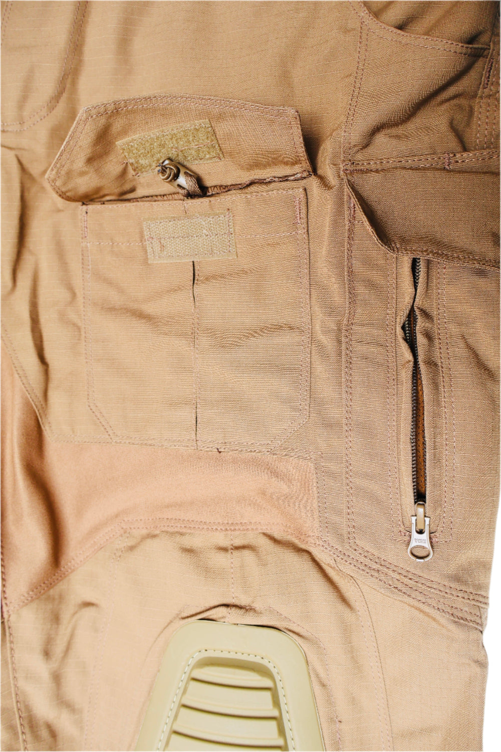 Close-up of a tan pants with zippers and pockets on a white background
